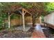 Rustic wooden outdoor structure with vine coverage next to a brick pathway at 719 S Summerlin Ave, Orlando, FL 32801