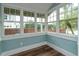 Bright sunroom with large windows, wood floors, and blue walls at 719 S Summerlin Ave, Orlando, FL 32801