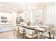 Bright dining area featuring a modern chandelier and a large table with seating for six at 7940 Formosa Valley Pl, Kissimmee, FL 34747