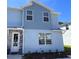 Charming two-story home featuring a textured stone front door and light blue exterior at 7940 Formosa Valley Pl, Kissimmee, FL 34747