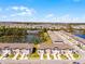 An aerial view of townhomes near a serene pond, showcasing the community layout at 824 Longboat Dr, Davenport, FL 33896