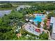 A full aerial view of a community pool, play area, and lush surroundings at 824 Longboat Dr, Davenport, FL 33896