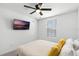 Bright bedroom featuring ceiling fan and mounted TV at 824 Longboat Dr, Davenport, FL 33896