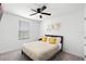 Cozy bedroom with ceiling fan and natural light from the window at 824 Longboat Dr, Davenport, FL 33896