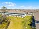 A long view of townhomes with well manicured green space and common sitting area at 824 Longboat Dr, Davenport, FL 33896