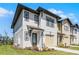 Charming two-story home with white siding, a single-car garage, and a neatly landscaped front yard at 824 Longboat Dr, Davenport, FL 33896