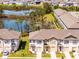 A street view of townhomes, highlighting their front-facing garages and well-kept lawns at 824 Longboat Dr, Davenport, FL 33896