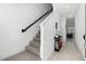 Inviting hallway with stylish decor, staircase, and tile flooring leading into the living area at 824 Longboat Dr, Davenport, FL 33896