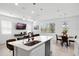 Open floor plan kitchen features a kitchen island with seating, and a living area at 824 Longboat Dr, Davenport, FL 33896