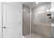 Stylish tiled shower with glass door, modern fixtures, and ample lighting at 824 Longboat Dr, Davenport, FL 33896