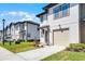 Street view of a row of modern townhomes with well-kept lawns and attractive facades at 824 Longboat Dr, Davenport, FL 33896