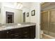 Double sink bathroom featuring a granite countertop and access to the shower at 8801 Rhodes St, Kissimmee, FL 34747