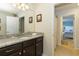 Bathroom featuring a granite countertop vanity and a doorway to the bedroom at 8801 Rhodes St, Kissimmee, FL 34747