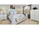 Cozy bedroom with a queen-size bed, floral bedding, and a view from the window at 8801 Rhodes St, Kissimmee, FL 34747