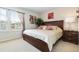 Comfortable bedroom with a queen-size bed, window, and warm lighting at 8801 Rhodes St, Kissimmee, FL 34747