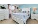 Stylish bedroom with blue accent wall, white furniture, and a bright window view at 8801 Rhodes St, Kissimmee, FL 34747