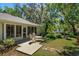 Backyard featuring a seating area on a wood deck, lush green landscaping and mature trees at 2930 Westgate Dr, Eustis, FL 32726