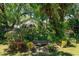 A small pond is surrounded by lush landscaping in this peaceful backyard space at 2930 Westgate Dr, Eustis, FL 32726