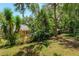 Serene backyard space boasting verdant landscaping offering a private outdoor retreat at 2930 Westgate Dr, Eustis, FL 32726