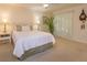 Cozy bedroom with natural light, neutral tones, carpet, and a bed dressed in white linens at 2930 Westgate Dr, Eustis, FL 32726