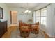 Traditional dining room featuring decorative chandelier and large sunny windows at 2930 Westgate Dr, Eustis, FL 32726