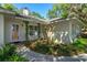 Inviting front entrance with a well-manicured garden and covered porch at 2930 Westgate Dr, Eustis, FL 32726