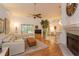 Bright living room with a fireplace, ceiling fan and sliding door to the outside at 2930 Westgate Dr, Eustis, FL 32726