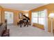 Well-lit living room featuring a grand piano and a decorative painting at 2930 Westgate Dr, Eustis, FL 32726