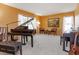 Well-lit living room featuring a grand piano and a decorative painting at 2930 Westgate Dr, Eustis, FL 32726