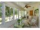 Bright sunroom with ample windows offering a view of the outdoors, ceiling fan, and tile flooring at 2930 Westgate Dr, Eustis, FL 32726