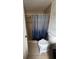 Simple bathroom featuring a step-in shower with tiled surround and a patterned shower curtain at 100 Huntswood Ct, Longwood, FL 32750