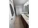 Bathroom with double sink vanity, granite countertop, and a view of the shower at 100 Huntswood Ct, Longwood, FL 32750