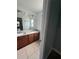 Bathroom with a double sink vanity featuring granite counters and wood cabinets at 100 Huntswood Ct, Longwood, FL 32750
