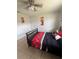 Bedroom featuring a dark wood frame bed with a red and black comforter and tile floors at 100 Huntswood Ct, Longwood, FL 32750