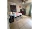 Bedroom with tile floors and a bed, along with a desk and shelving unit at 100 Huntswood Ct, Longwood, FL 32750