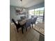Dining area with stylish chandelier, table, seating, and outdoor views at 100 Huntswood Ct, Longwood, FL 32750