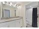 Well-lit bathroom boasts double sinks, granite countertops, and a shower-tub combination, perfect for modern living at 10509 Authors Way, Orlando, FL 32832