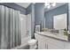 Cozy bathroom featuring modern fixtures, granite countertops, and stylish gray walls at 10509 Authors Way, Orlando, FL 32832