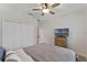 Comfortable bedroom with a ceiling fan, closet, and light wood dresser with a TV at 10509 Authors Way, Orlando, FL 32832