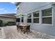 Outdoor dining area on a brick patio, featuring a table, chairs, and umbrella, perfect for enjoying outdoor meals at 10509 Authors Way, Orlando, FL 32832