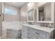 Bathroom featuring a jacuzzi tub and double sinks at 10544 Parkway Dr, Clermont, FL 34711