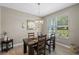 Charming dining room featuring a wood table and a stylish chandelier above at 10544 Parkway Dr, Clermont, FL 34711