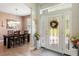 Foyer view featuring the dining room with a wooden table and pendant lighting at 10544 Parkway Dr, Clermont, FL 34711