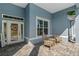 Charming front porch with blue siding, a decorative door, and a cozy seating area at 10544 Parkway Dr, Clermont, FL 34711