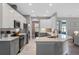 Well-lit kitchen featuring stainless steel appliances, gray cabinets, white countertops, and an open design at 10544 Parkway Dr, Clermont, FL 34711