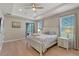 Bedroom featuring wood floors, a ceiling fan, and ensuite bathroom at 10544 Parkway Dr, Clermont, FL 34711