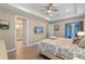 Comfortable bedroom featuring wood floors, ceiling fan, and ensuite bathroom at 10544 Parkway Dr, Clermont, FL 34711