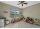 playroom showcasing a play kitchen, a table with chairs, and various toys scattered across the floor at 10544 Parkway Dr, Clermont, FL 34711