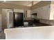 Kitchen featuring white cabinets and black appliances, seamlessly connecting to the other rooms at 1060 Walt Williams Rd, Lakeland, FL 33809