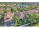 Aerial view of a residential neighborhood with a lake and well-maintained properties at 11754 Barletta Dr, Orlando, FL 32827